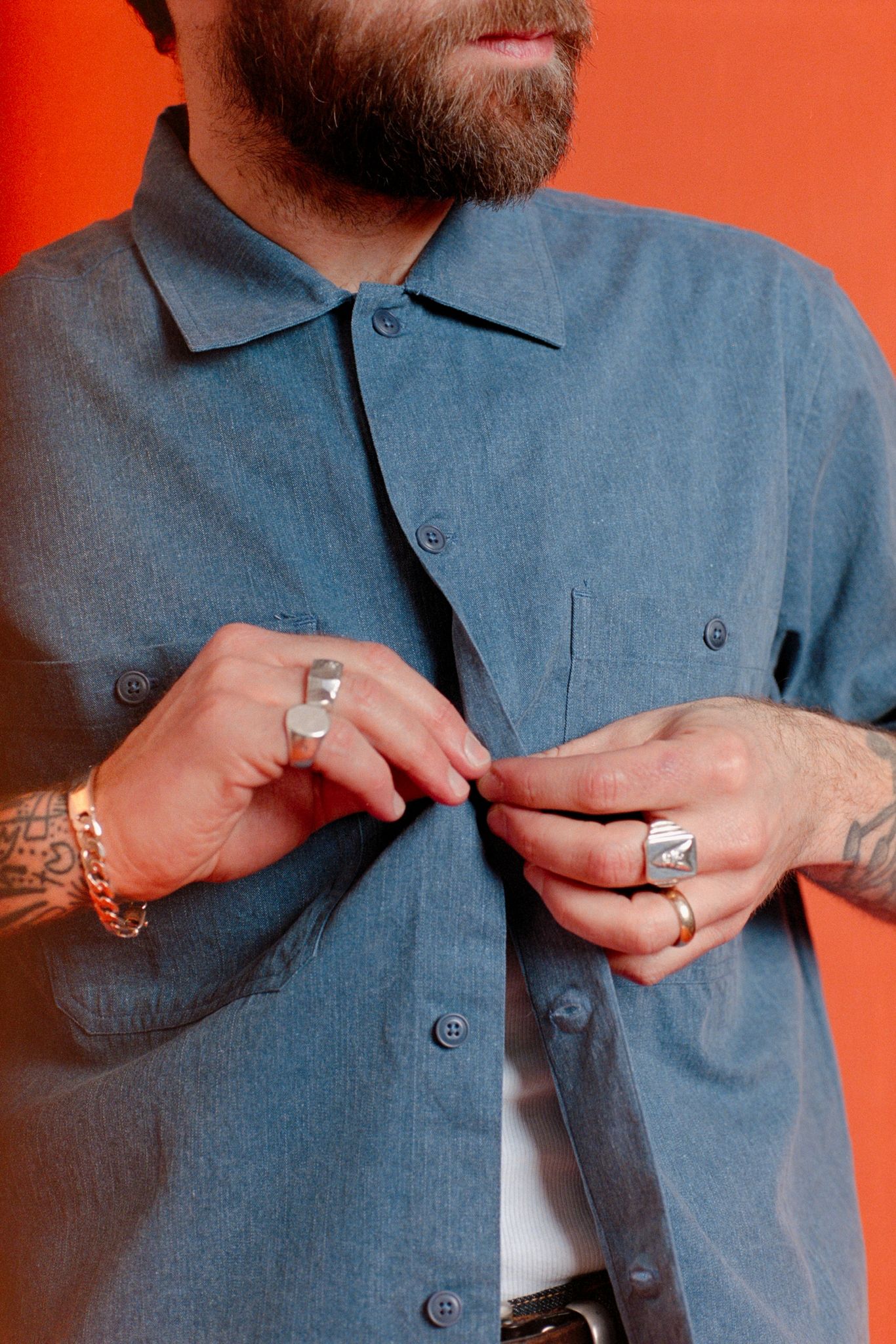 Person wearing a blue shirt with a red background